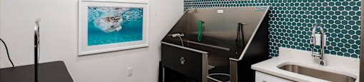 a small bathroom with a sink and a bath tub and a sink with a counter
