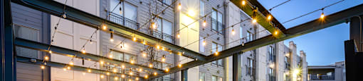 a rendering of a patio with chairs and tables and lights