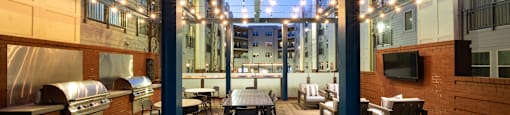 a patio with a table and chairs in a courtyard