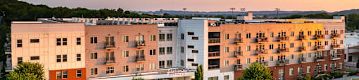 an aerial view of an apartment building at sunset
