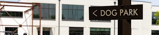 a dog park sign in front of a building