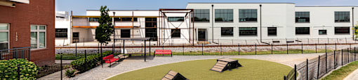 a courtyard with benches and a building in the background