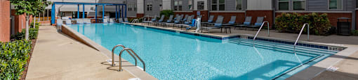 a swimming pool in front of an apartment building