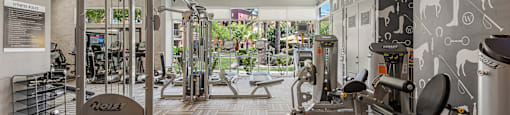 a spacious fitness center with treadmills and other exercise equipment