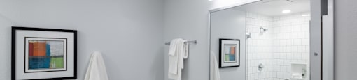 a bathroom with a large mirror and a toilet next to a sink