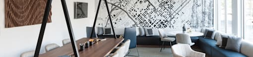 a room with a table and chairs and a large mural on the wall