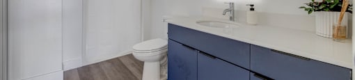 A bathroom with a white toilet and a white sink.