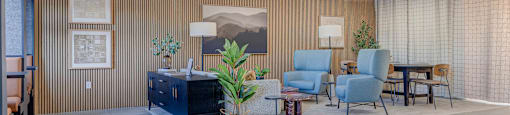 A modern living room with a blue sofa and a wooden cabinet.