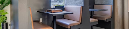 A modern dining area with a table, chairs, and pendant lights.