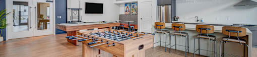 A game table with chairs is in the middle of a room.