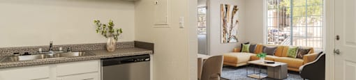 an open kitchen and living room with a couch and a table