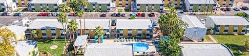 an aerial view of a building with cars parked in a parking lot