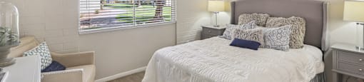 a bedroom with a large bed and a ceiling fan