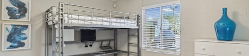 a bedroom with a bunk bed and a ceiling fan