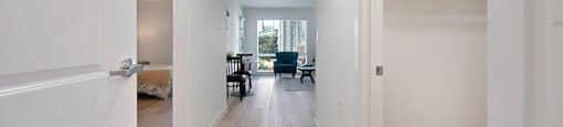 a bedroom with a medium sized bed and a chair in a room with a desk and a at Citrus Heights Apartments, Citrus Heights, CA