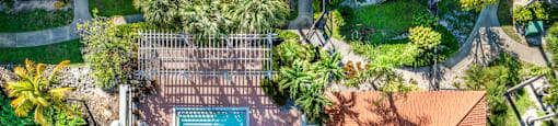 A large swimming pool surrounded by a wooden deck and a house.