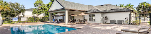 A house with a pool in the backyard. at Cascades at Clear Lake Apartments, Apartments, Ft. Myers, FL
