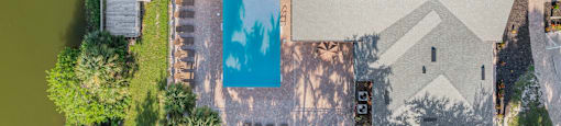 An aerial view of a house with a pool in the backyard. at Cascades at Clear Lake Apartments, Apartments, Ft. Myers, FL
