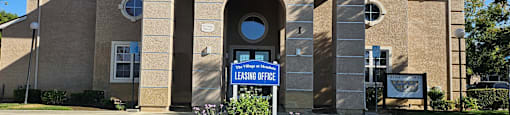 A building with a sign that says "Leasing Office".