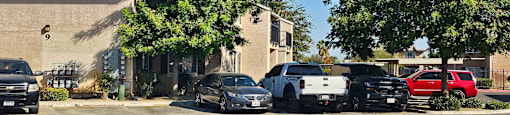 A black car is parked in front of a house.