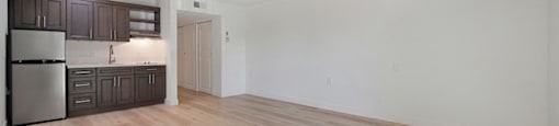a kitchen and living room with white walls and hardwood floors at Citrus Heights Apartments, Citrus Heights, CA,95621