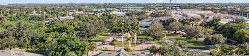 A house with a pool in the middle of a green field. at Cascades at Clear Lake Apartments, Ft. Myers, FL, 33908