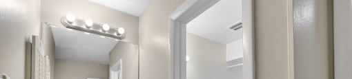 A bathroom with a sink, mirror, and toilet. at Foxcroft Apartments, Florida, 33614