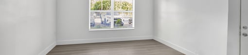 A white room with a window and a wooden floor. at Cascades at Clear Lake Apartments, Florida, 33908