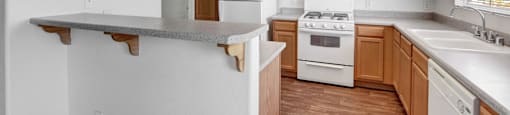 a kitchen with white appliances and wooden cabinets