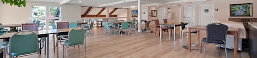 a large room with wooden floors and tables and chairs at Citrus Heights Apartments, Citrus Heights, CA,95621