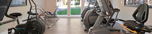 a gym with cardio equipment and a large window with a view of the street at Citrus Heights Apartments, California, 95621