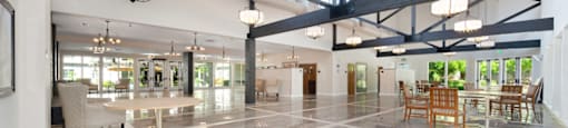 a large open room with a marble floor and exposed beams