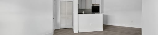 A spacious room with wooden flooring and white walls. at Cascades at Clear Lake Apartments, Ft. Myers, FL, 33908