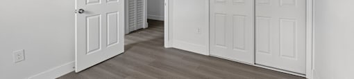 A room with two white doors and a light brown floor. at Cascades at Clear Lake Apartments, Florida, 33908