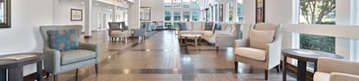 a lobby with chairs and couches at The Crest at Citrus Heights, California