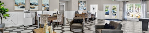 A spacious living room with a patterned floor and a large chandelier. at Cascades at Clear Lake Apartments, Ft. Myers, Florida