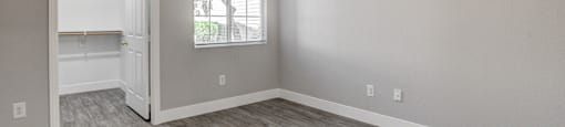A room with a ceiling fan and a window.