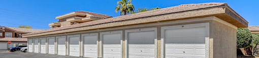 A row of garage doors in front of a building.