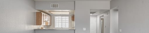 A spacious room with a window and a door.