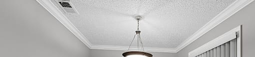 A room with a wooden floor and a ceiling fan.