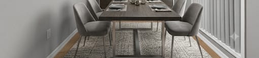 A dining room with a table set for six.