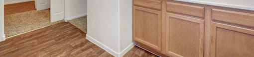 A kitchen with wooden cabinets and a white countertop.