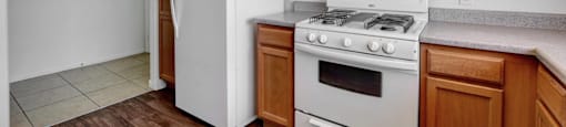 A kitchen with a white refrigerator and stove.