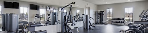 A spacious gym with various exercise equipment.