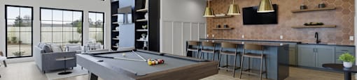 A billiard table is in the middle of a room with a pool table light.