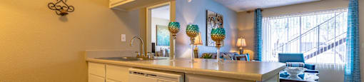 A kitchen with white cabinets and a countertop.
