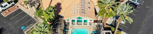A large building with a pool in the middle of a parking lot.