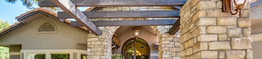 A house with a stone pillar and archway entrance.
