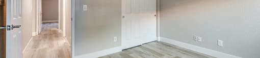 A room with wooden floors and white walls.