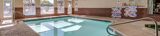 A large indoor swimming pool with a skylight above it.